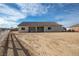 Backyard of home featuring dirt landscaping, fencing, and the rear of the house at 521 Antelope Ave, Pahrump, NV 89060