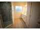 Bathroom with double vanity, marble shower, and light wood floor at 521 Antelope Ave, Pahrump, NV 89060