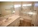 Bathroom with a bathtub, marble tile, and white vanity at 521 Antelope Ave, Pahrump, NV 89060