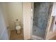 Bathroom view showcasing a toilet and a glass-enclosed marble shower at 521 Antelope Ave, Pahrump, NV 89060