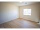 Bedroom features wood-look flooring, a window, and neutral paint at 521 Antelope Ave, Pahrump, NV 89060