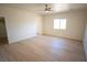 Spacious bedroom featuring neutral walls, wood look flooring, and a ceiling fan at 521 Antelope Ave, Pahrump, NV 89060