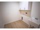 Functional laundry room with overhead cabinets and utility sink at 521 Antelope Ave, Pahrump, NV 89060