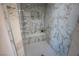 Close up of a walk-in shower with marble tiling and a built-in bench at 521 Antelope Ave, Pahrump, NV 89060