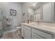 Modern bathroom with white cabinets and a large vanity mirror at 5260 Brayden Ct, Las Vegas, NV 89131