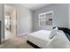 Bright bedroom with a queen bed and access to another room at 5260 Brayden Ct, Las Vegas, NV 89131