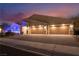 Three-car garage home with modern exterior and lighting at 5260 Brayden Ct, Las Vegas, NV 89131