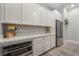 Modern kitchen with white cabinets and stainless steel appliances at 5260 Brayden Ct, Las Vegas, NV 89131