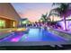 Luxury pool with waterfall feature and fire pit at sunset at 5260 Brayden Ct, Las Vegas, NV 89131