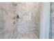 Large walk-in shower with marble tile and glass enclosure at 5260 Brayden Ct, Las Vegas, NV 89131