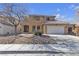 Two-story house with a tan exterior, green door and a two-car garage at 5313 Dawn Break Canyon St, North Las Vegas, NV 89031