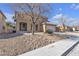 Two-story house with a tan exterior, green door and a two-car garage at 5313 Dawn Break Canyon St, North Las Vegas, NV 89031