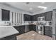 Modern kitchen with dark cabinetry, quartz countertops, and stainless steel appliances at 5313 Dawn Break Canyon St, North Las Vegas, NV 89031