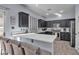 Modern kitchen featuring dark cabinetry, quartz countertops, and stainless steel appliances at 5313 Dawn Break Canyon St, North Las Vegas, NV 89031