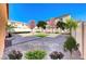 Virtually staged backyard with patio, decorative rock, trees, and artificial turf at 5428 Brazelton St, North Las Vegas, NV 89081