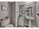 Small half bathroom with pedestal sink and white vanity at 5428 Brazelton St, North Las Vegas, NV 89081