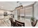 Dining area with a wooden table, and a modern light fixture at 5428 Brazelton St, North Las Vegas, NV 89081