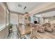 Open-concept dining room with a view of the living room with wood-look flooring at 5428 Brazelton St, North Las Vegas, NV 89081