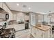 Bright kitchen with white cabinets, granite countertops, island, and stainless steel appliances at 5428 Brazelton St, North Las Vegas, NV 89081