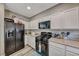 Galley-style kitchen features stainless steel appliances, granite countertops, and white cabinets at 5428 Brazelton St, North Las Vegas, NV 89081