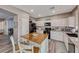 Open-concept kitchen features a wooden island, white cabinets, and stainless steel appliances at 5428 Brazelton St, North Las Vegas, NV 89081