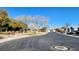 Residential street with houses, trees, and mountain view at 5633 Bridgehampton Ave, Las Vegas, NV 89130