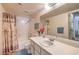 Bathroom with extended vanity, shower-tub combo, and framed mirror at 5655 Vineyard Ln # 0, Las Vegas, NV 89110