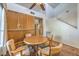 Dining space with a round wooden table and seating for four beneath a ceiling fan at 5655 Vineyard Ln # 0, Las Vegas, NV 89110