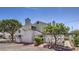 Home exterior featuring neutral stucco, a chimney, and desert landscaping at 5655 Vineyard Ln # 0, Las Vegas, NV 89110