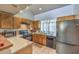 Functional kitchen with stainless steel refrigerator and plenty of cabinet space at 5655 Vineyard Ln # 0, Las Vegas, NV 89110