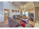 Cozy living room featuring a fireplace, comfortable furniture, and vaulted ceiling at 5655 Vineyard Ln # 0, Las Vegas, NV 89110