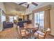 Open-concept living room with vaulted ceilings, ceiling fan, and dining area at 5655 Vineyard Ln # 0, Las Vegas, NV 89110