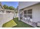 Cozy patio space with artificial grass and seating area for outdoor enjoyment and privacy at 5655 Vineyard Ln # 0, Las Vegas, NV 89110