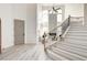 Bright and spacious entryway with a modern staircase and light hardwood floors at 5737 Heather Breeze Ct, Las Vegas, NV 89141