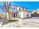 Two-story home with stucco exterior, attached garage, and landscaped yard at 5737 Heather Breeze Ct, Las Vegas, NV 89141