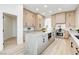 Modern kitchen with light wood cabinets, a large island, and stainless steel appliances at 5737 Heather Breeze Ct, Las Vegas, NV 89141