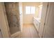 Bright bathroom featuring double sinks and a marble tiled shower at 5821 Genoa Ave, Pahrump, NV 89060