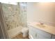 Well-lit bathroom featuring marble-patterned shower, toilet and vanity at 5821 Genoa Ave, Pahrump, NV 89060