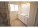 Bathroom featuring double sinks and a stunning marble tiled shower at 5821 Genoa Ave, Pahrump, NV 89060