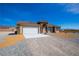 Inviting single story home with mountain views, a two-car garage, and gravel landscaping at 5821 Genoa Ave, Pahrump, NV 89060