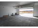 Spacious garage with an open door and views of the surrounding desert landscape at 5821 Genoa Ave, Pahrump, NV 89060