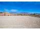 Expansive vacant land with desert vegetation and a mountain backdrop at 5821 Genoa Ave, Pahrump, NV 89060