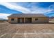 Back of a single story home highlighting the patio, windows and neutral exterior paint at 5821 Genoa Ave, Pahrump, NV 89060