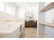 Elegant bathroom featuring a double vanity and a soaking tub at 602 Calcutta Ln, Henderson, NV 89015