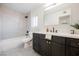 Modern bathroom with dark vanity and gray tile shower at 602 Calcutta Ln, Henderson, NV 89015