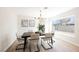 Elegant dining room featuring a modern chandelier and large window at 602 Calcutta Ln, Henderson, NV 89015