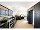 Modern kitchen with dark cabinetry, a large island, and stainless steel appliances at 602 Calcutta Ln, Henderson, NV 89015