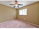 Inviting bedroom with a ceiling fan, a window with blinds, and neutral-toned walls at 6113 Breeders Cup St, Las Vegas, NV 89130