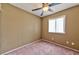 Cozy bedroom featuring neutral walls, a ceiling fan, and a bright window at 6113 Breeders Cup St, Las Vegas, NV 89130