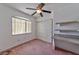 Bedroom with closet, desk area, and large window for natural light at 6113 Breeders Cup St, Las Vegas, NV 89130